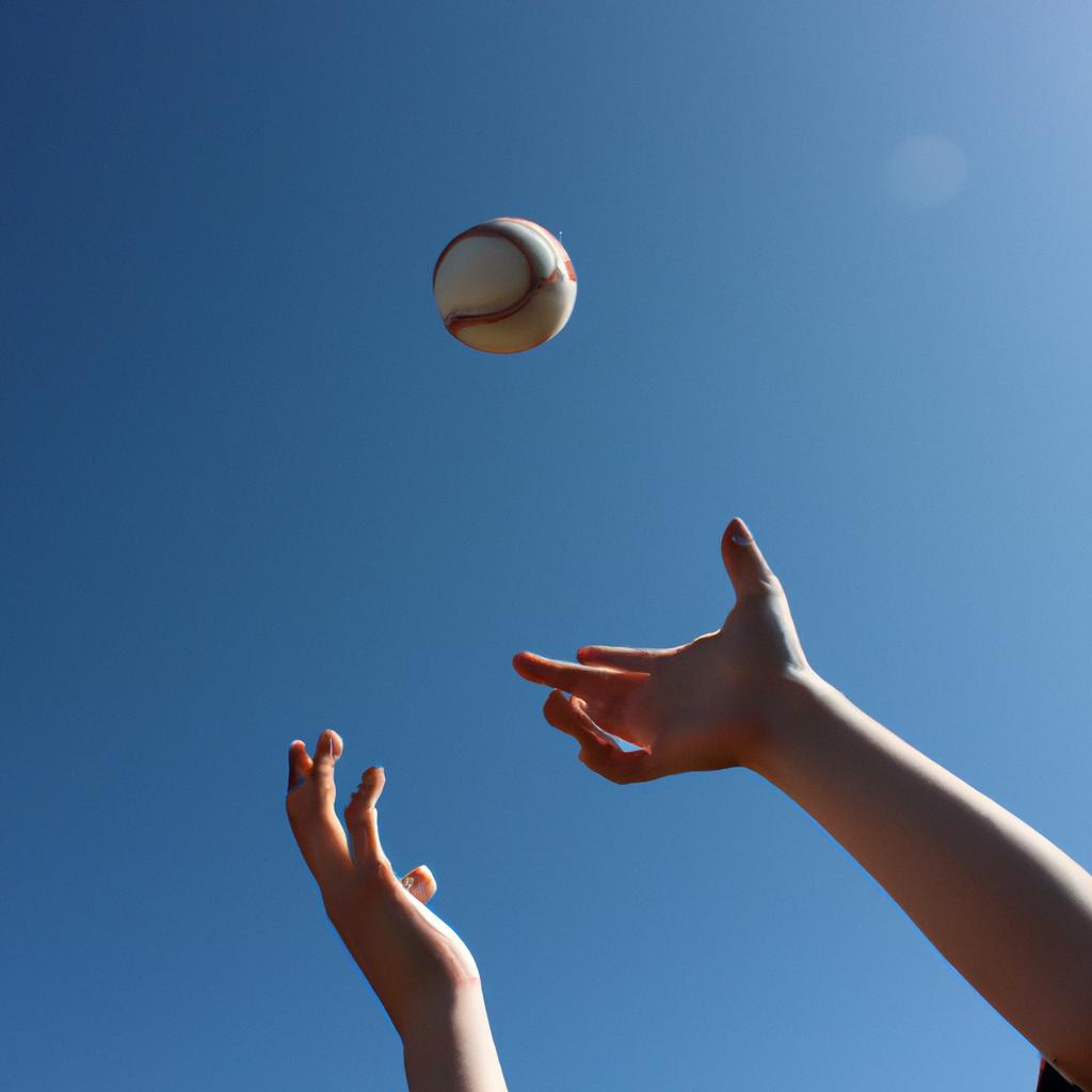 Person catching a baseball mid-air
