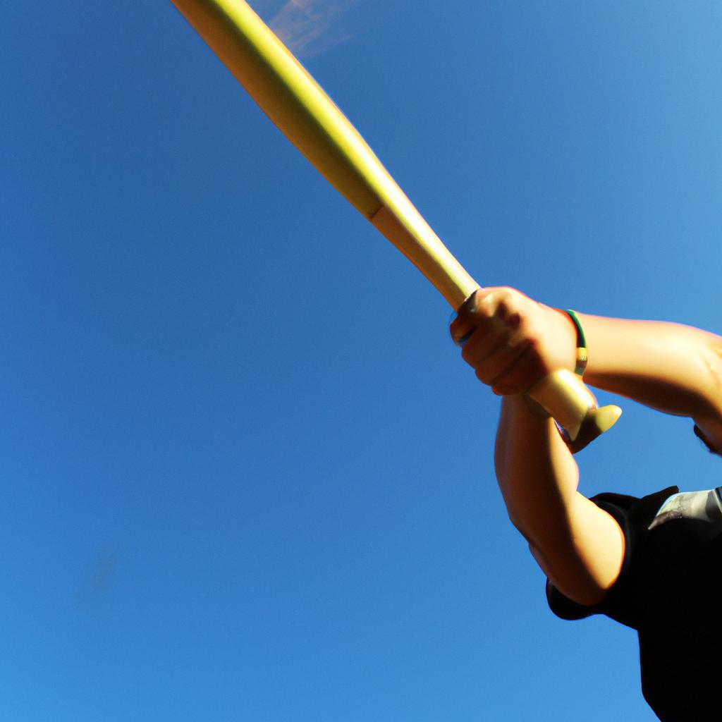 Person swinging baseball bat mid-air