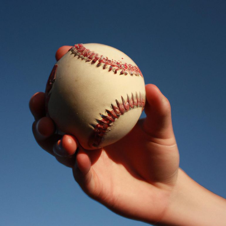 Person holding a baseball, demonstrating