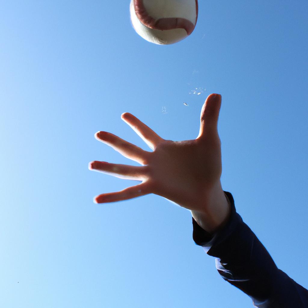 Person catching a baseball mid-air
